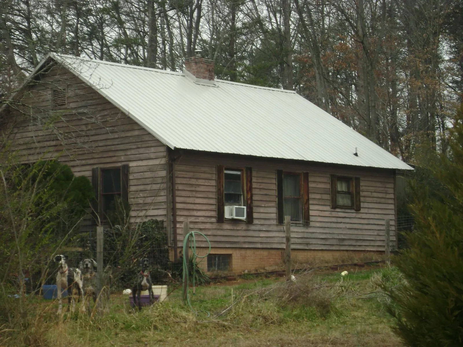 White metal roof on an old wood sided farmhouse, from a Metal Roof Installation job in Monson